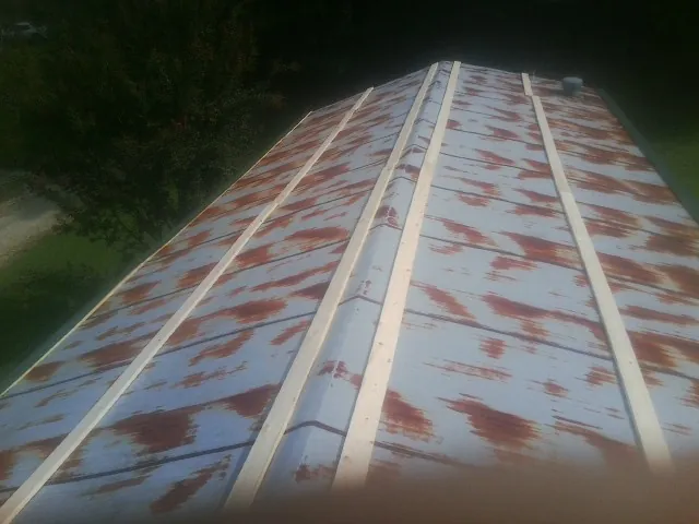 Rusted metal roof panels with new wood purlins before replacement — Storm Damage Roof Repair in Chimacum by Roofing Brothers